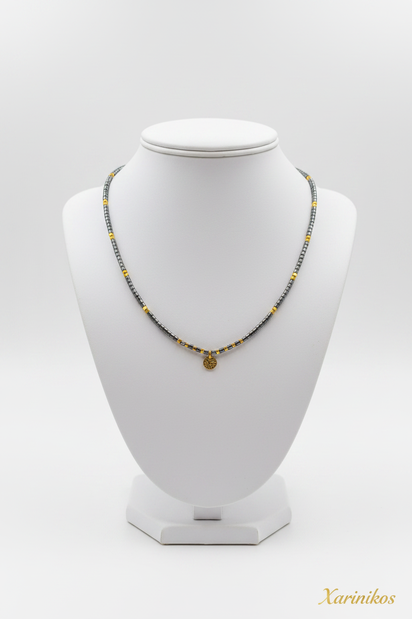 Gunmetal Gold Coin Choker on jewelry display