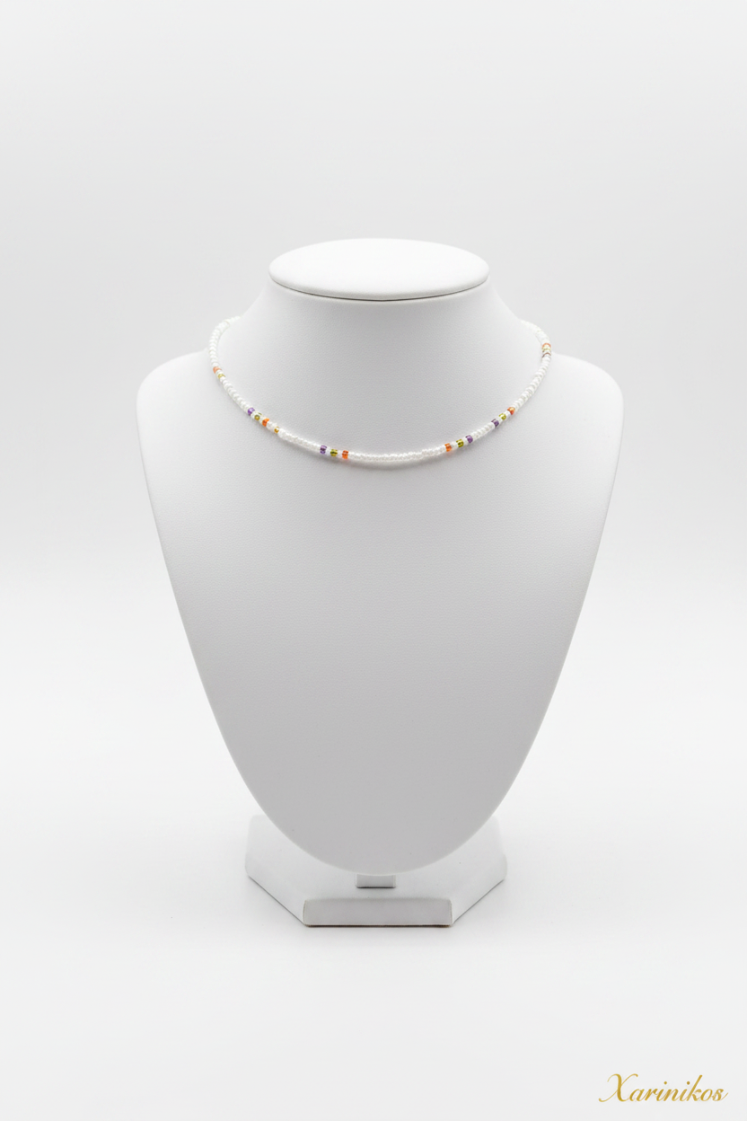White & Gold Seed Bead Choker on jewelry display