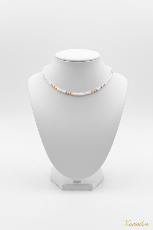 White & Gold Seed Bead Choker on jewelry display