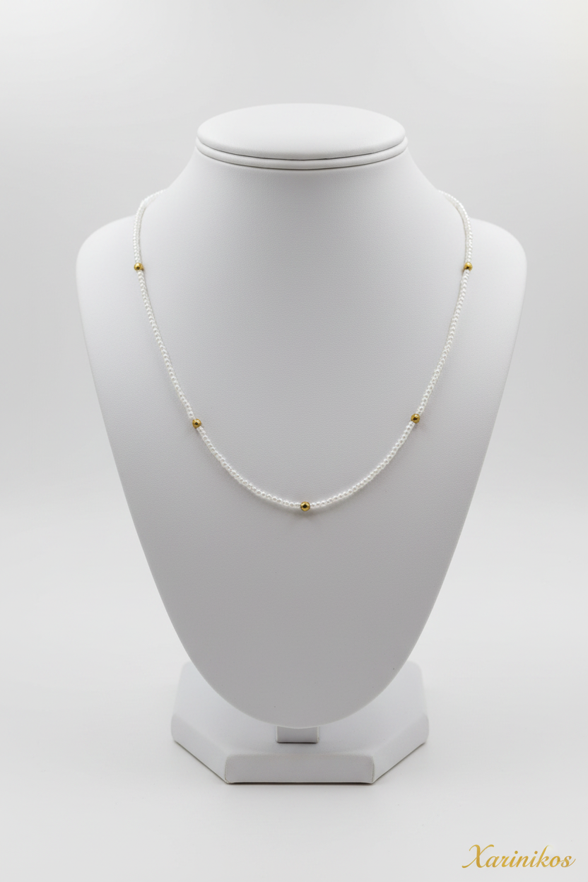 Delicate Pearl & Gold Necklace on jewelry display stand