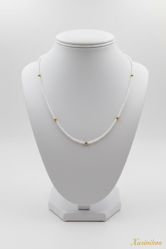 Delicate Pearl & Gold Necklace on jewelry display stand